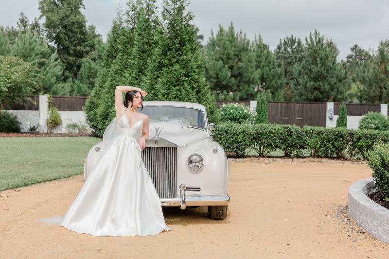 bride poses with classic car
