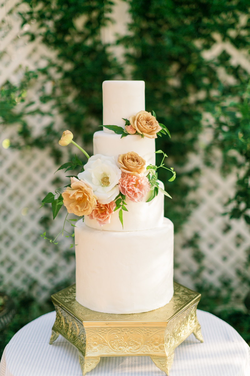 four tier white wedding cake with florals
