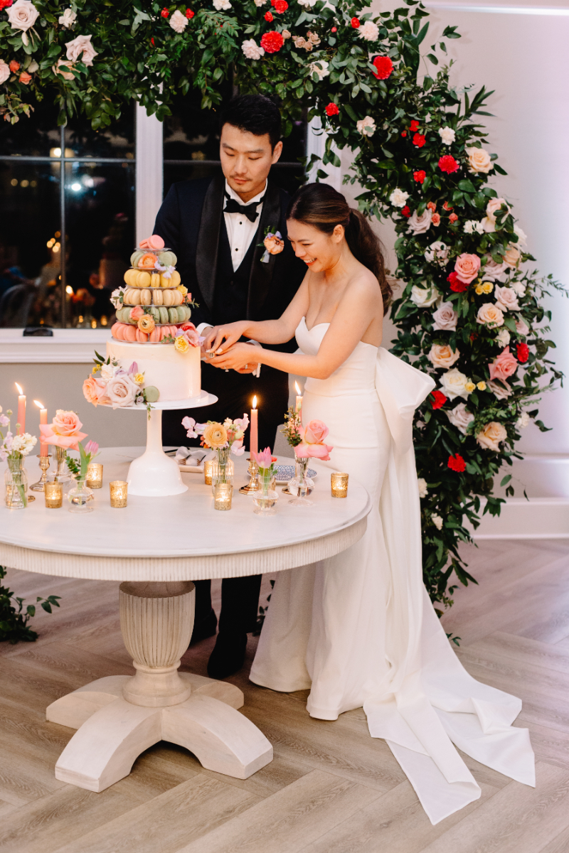 bride and groom "cut" the macaron in lieu of wedding cake