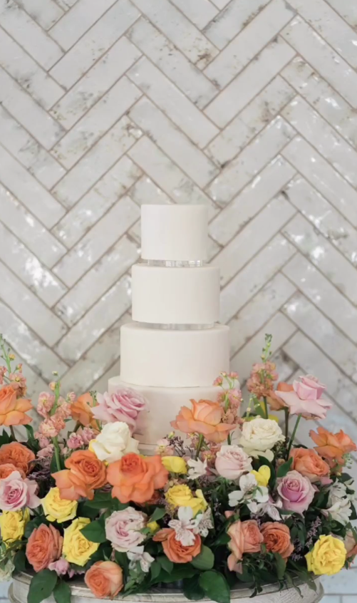 4 tier all white wedding cake with cake garden